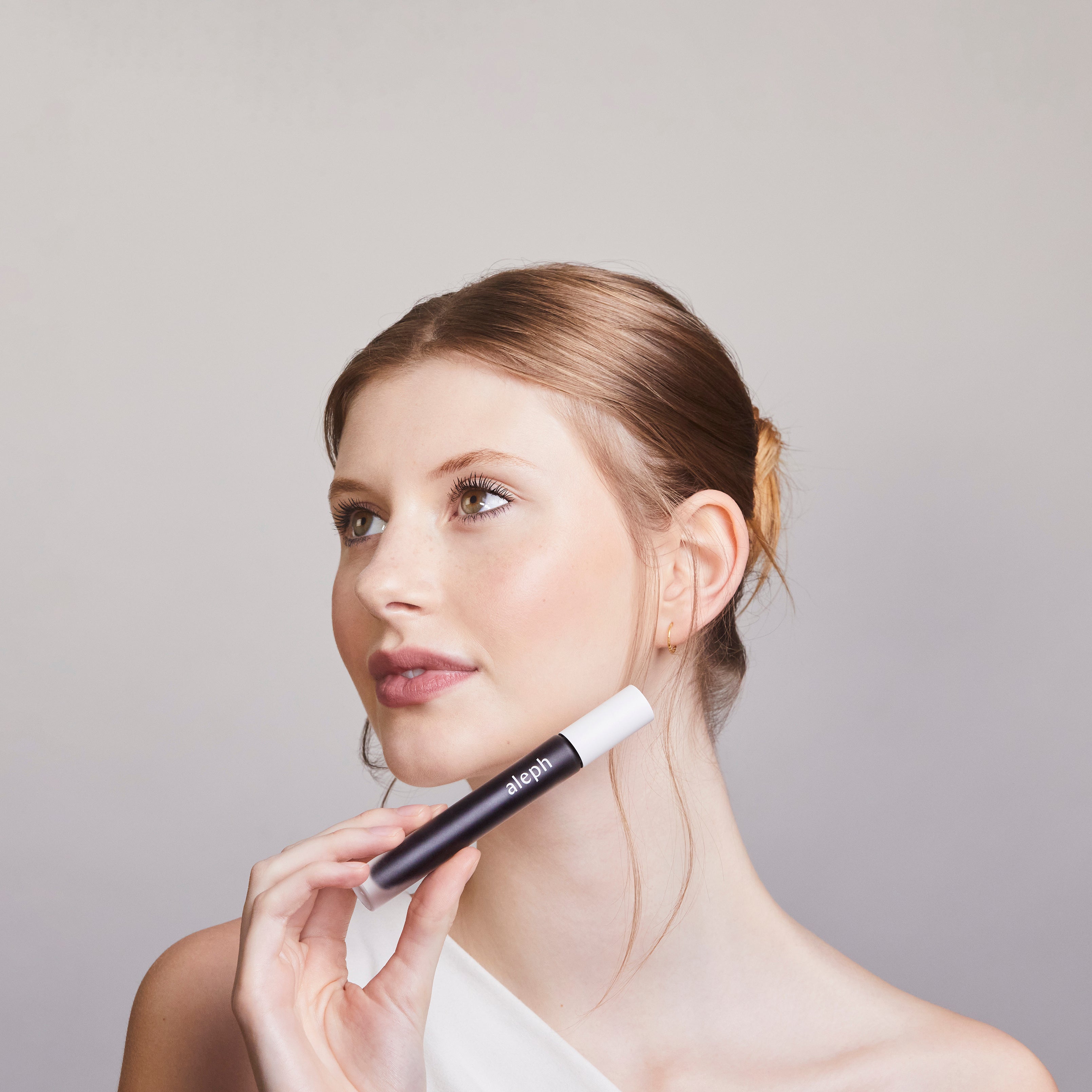 Woman holding Aleph Mascara
