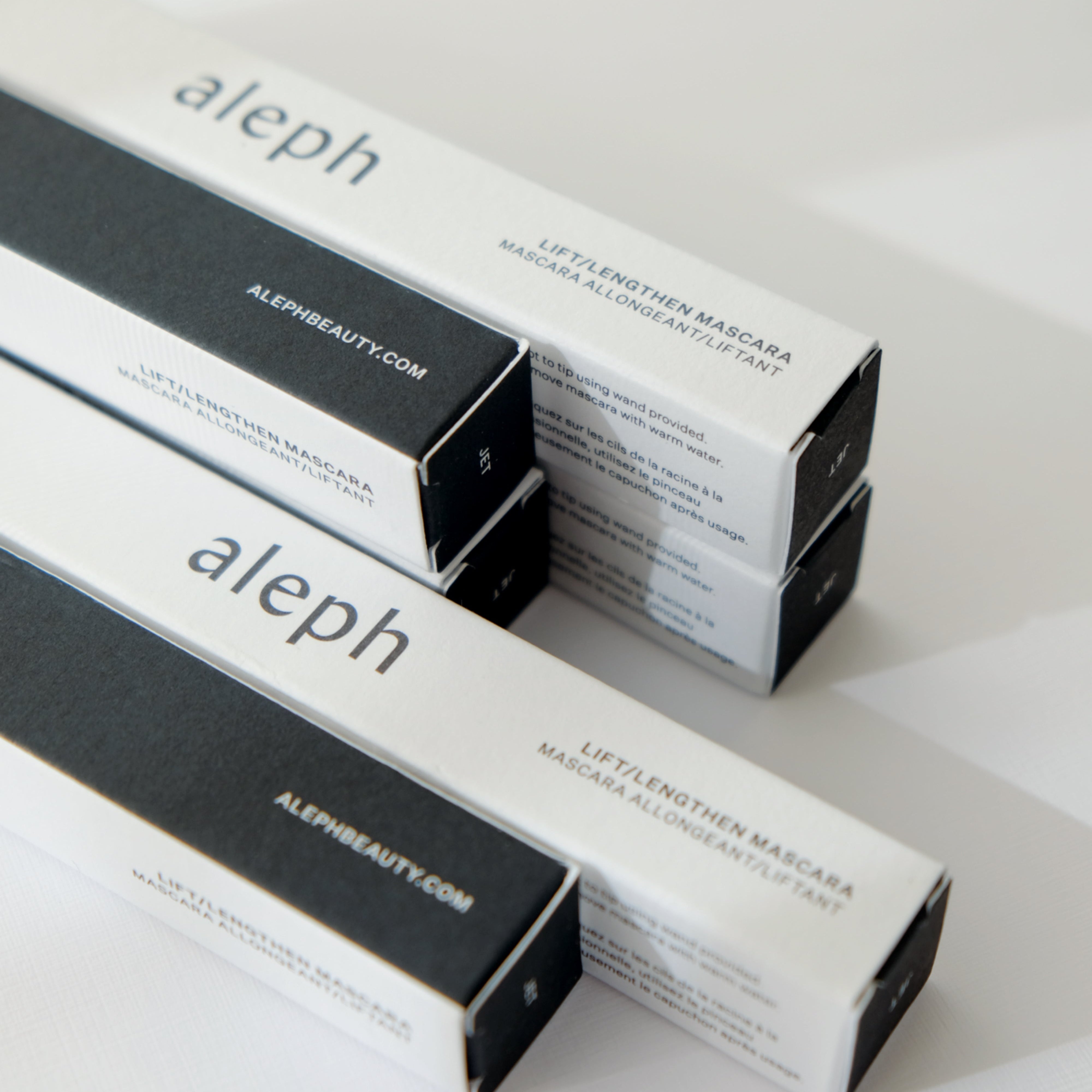 Stack of aleph beauty product boxes on a white background