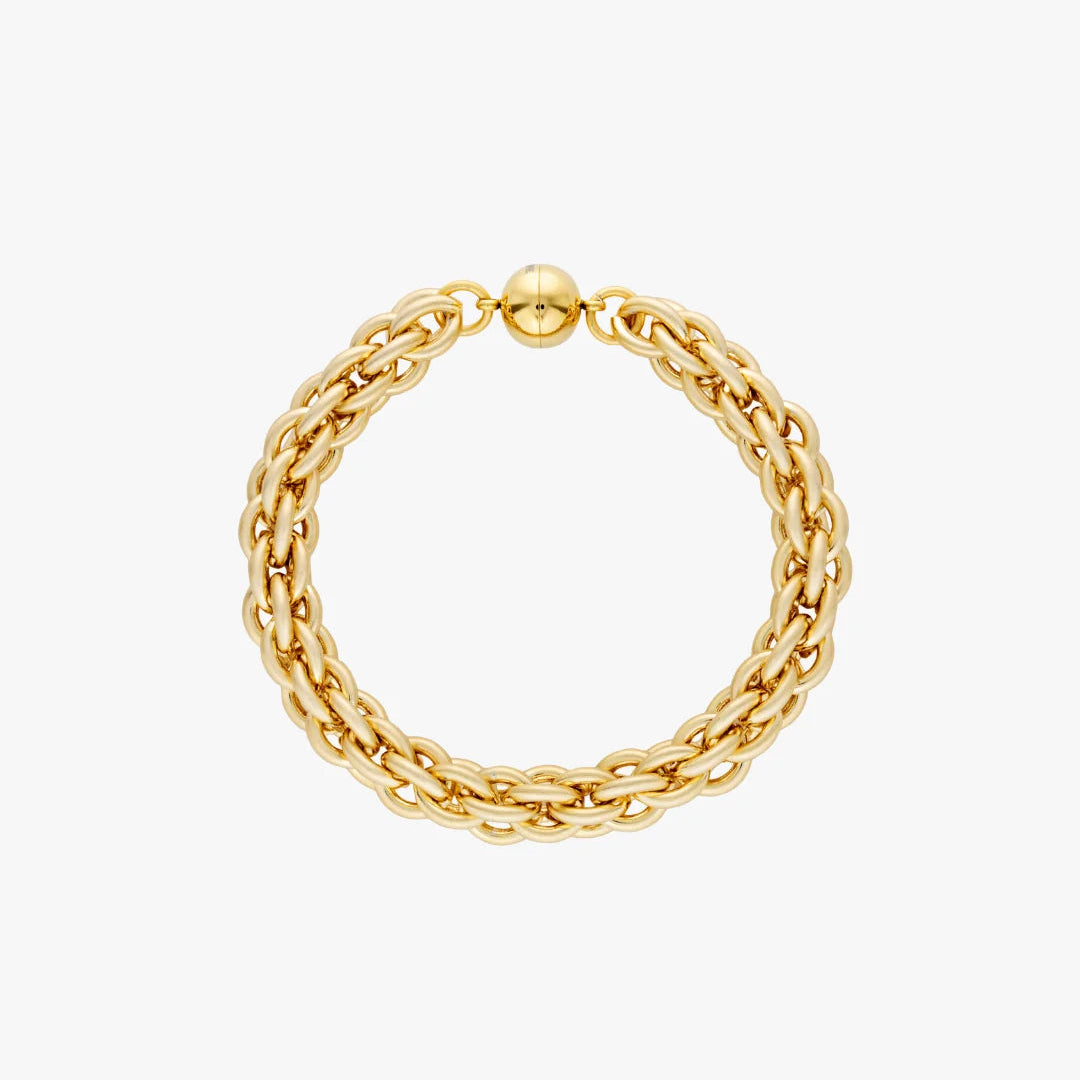 A gold chain bracelet with a textured, multi-strand design and a polished ball clasp, shown on a plain light gray background.