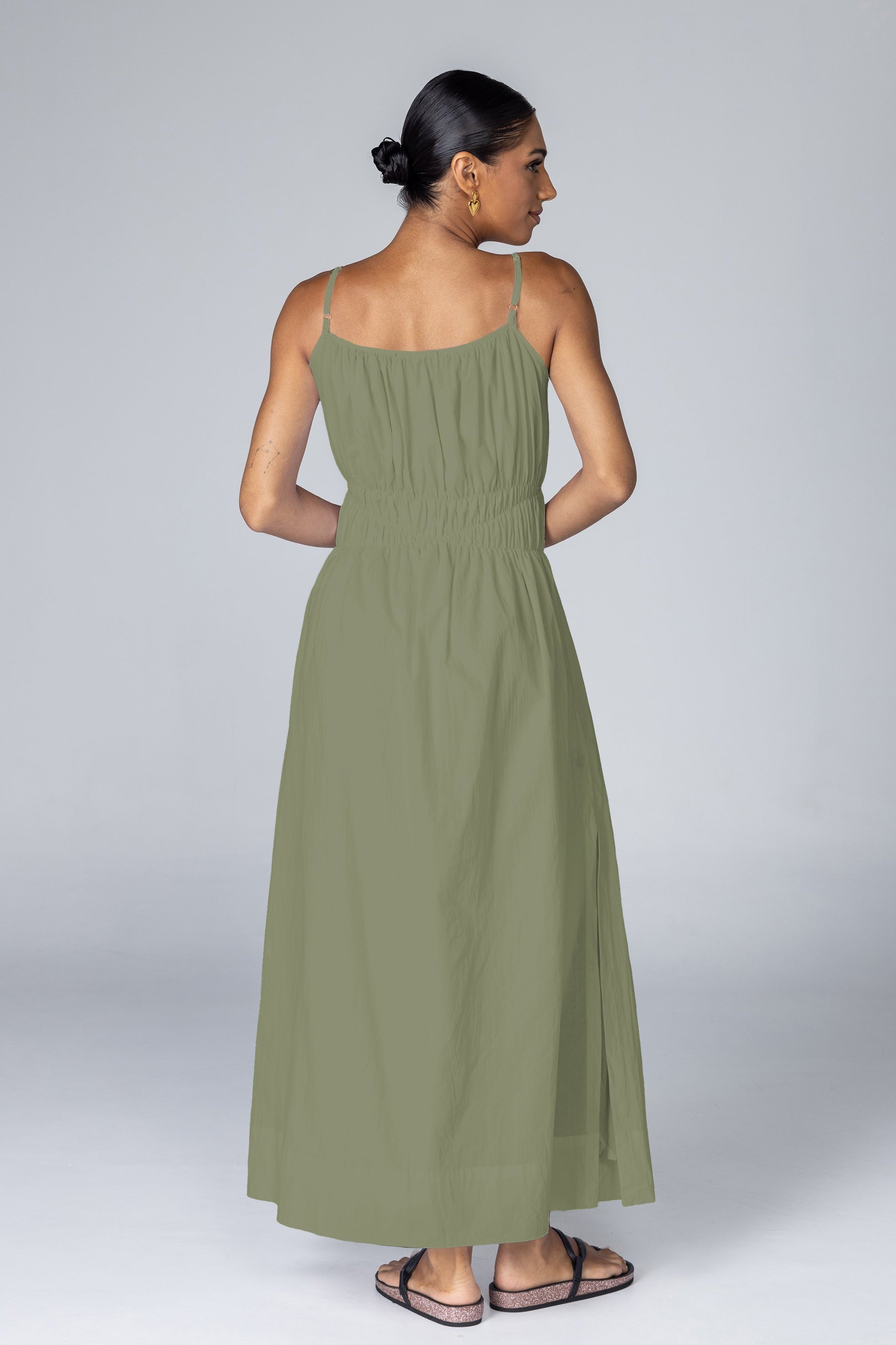 Woman wearing a green dress on a white background